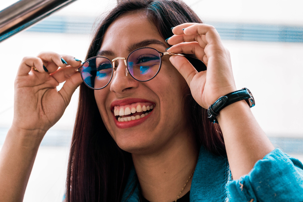 Happy woman trying on new glasses at Burlington Eye Optical